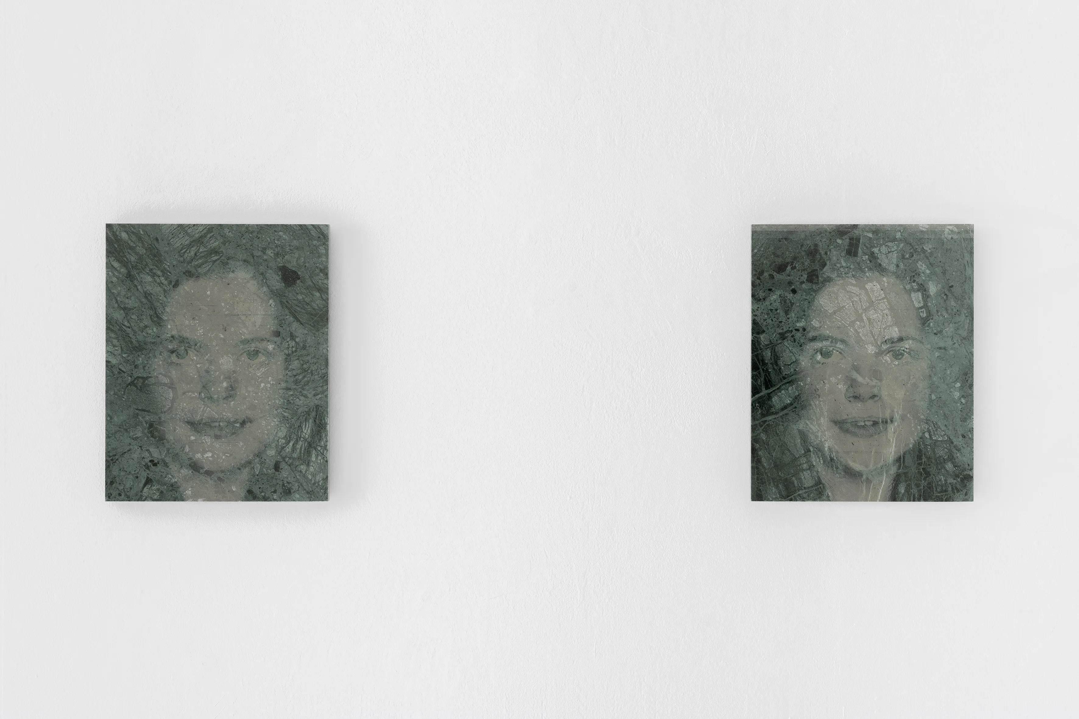 View of the AI-generated faces engraved on colored marble